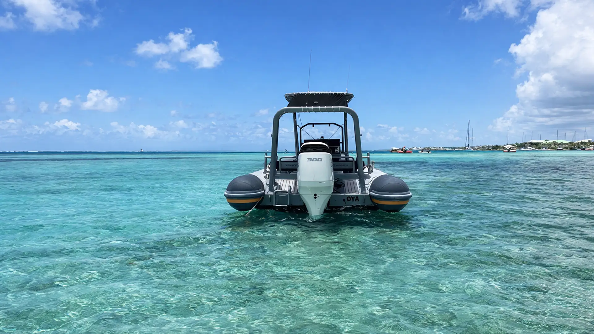 Arrière du bateau semi-rigide Highfield Patrol 760 avec moteur 300 chevaux dans un lagon turquoise en Guadeloupe